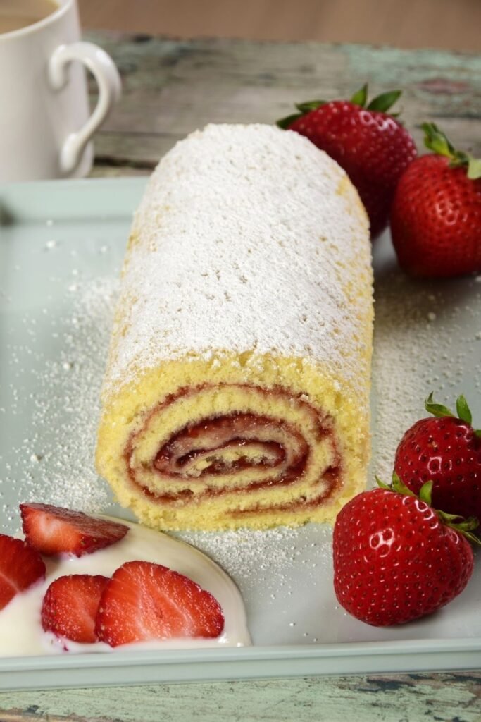 Mary Berry Swiss roll sponge rolled with strawberry jam and dusted with sugar