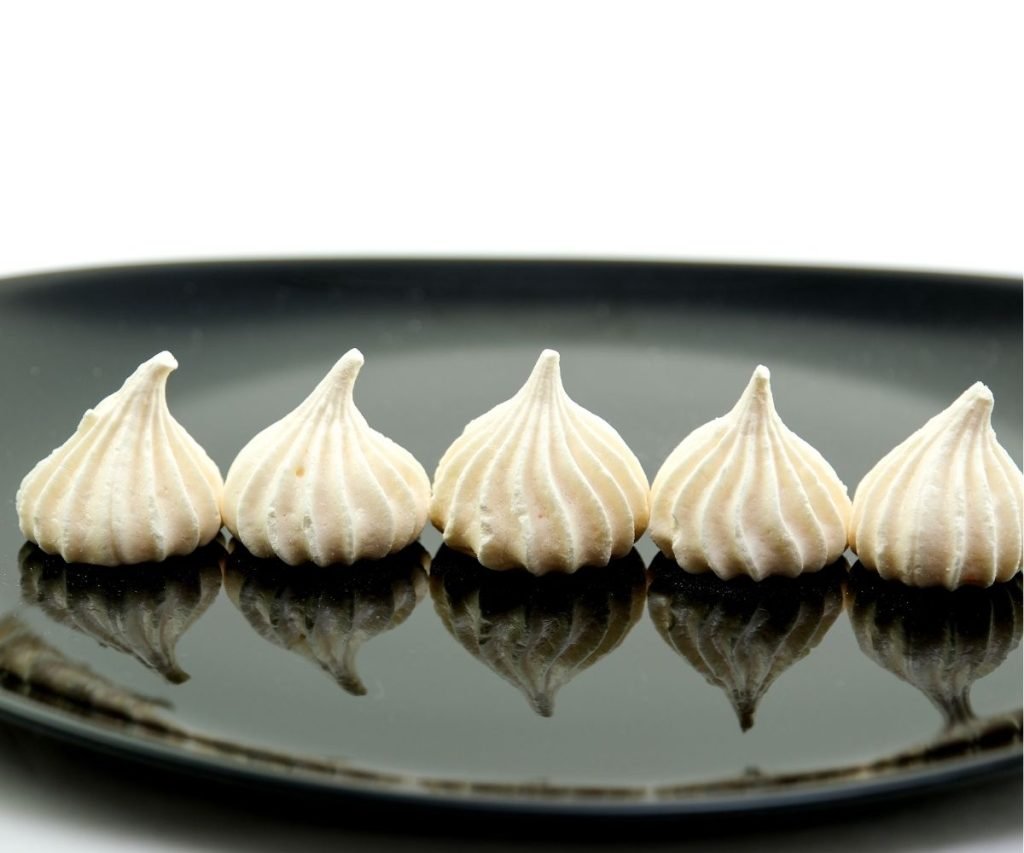 Mary Berry meringues sandwiched with whipped cream and dusted with sugar