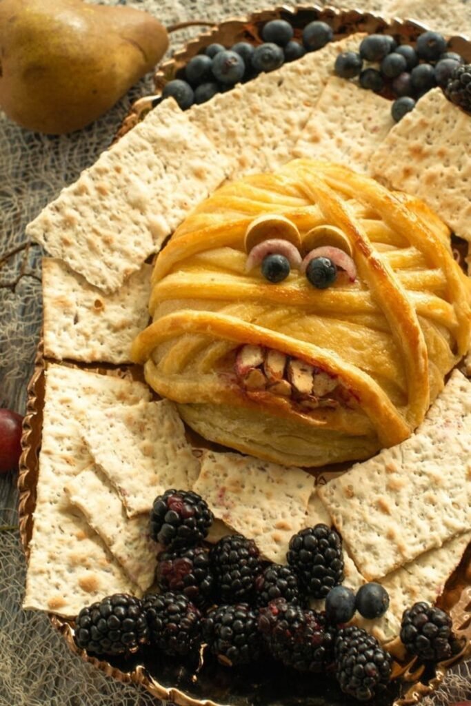 Mummy-Wrapped Baked Brie With Cranberry Blood Sauce