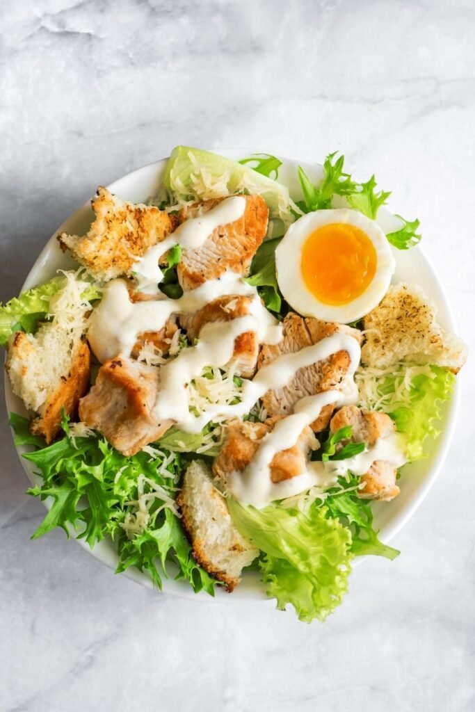 Caesar salad with crisp romaine, homemade garlic croutons and grated Parmesan