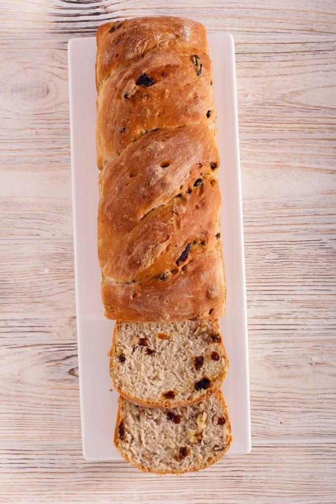 Cinnamon walnut and raisin loaf sliced on a board