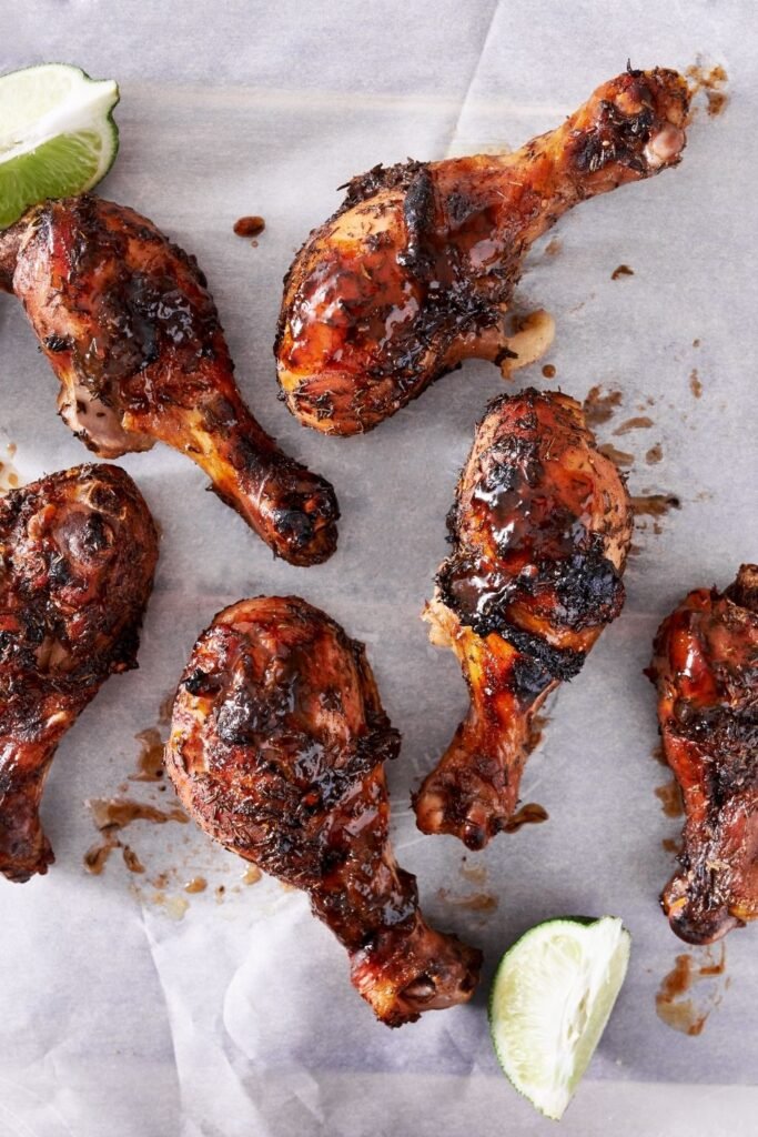 Jerk chicken recipe with charred Caribbean spiced chicken legs and grilled pineapple