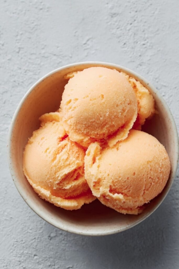 Mary Berry apricot sorbet served with fresh sliced apricots on top