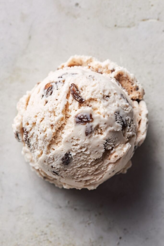 Mary Berry rum and raisin ice cream scooped into a bowl